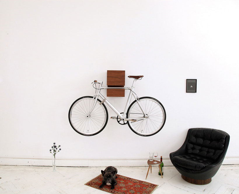 A bike hangs on a sculptural wooden wall shelf designed by Berlin brand Mikili. Photo via Artnau.