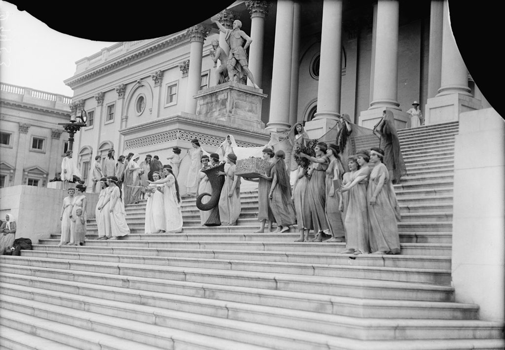 A group posing for photos on the Capitol steps in 1918. Photograph via Harris & Ewing Collection (Library of Congress). 