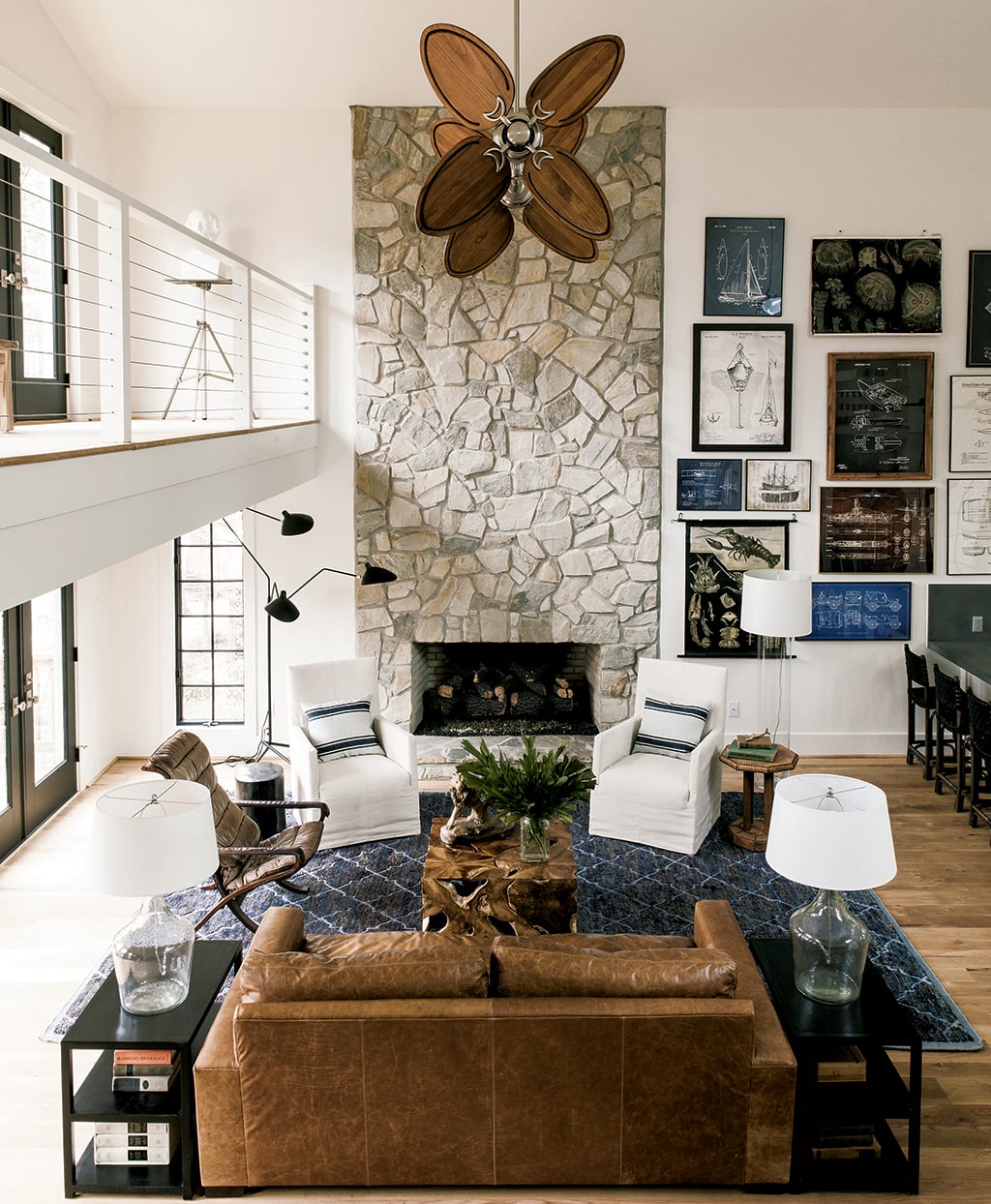 Lauren Liess Lake House: The great room's stone fireplaces is one of the few original features Liess kept intact. Photograph by Helen Norman.