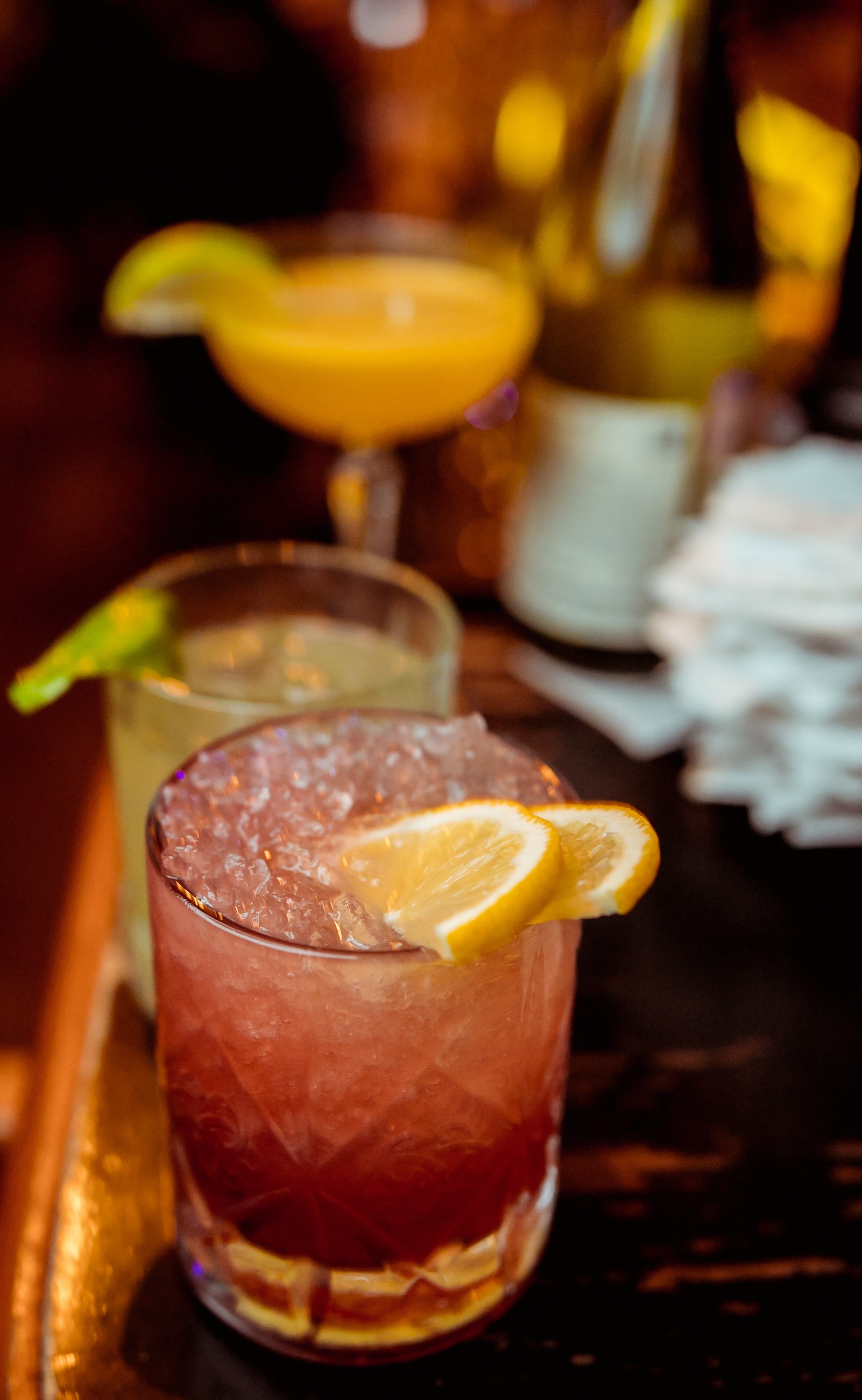 Glass,Of,Orange,Cocktail,Decorated,With,Lemon,At,Bar,Counter - Washingtonian
