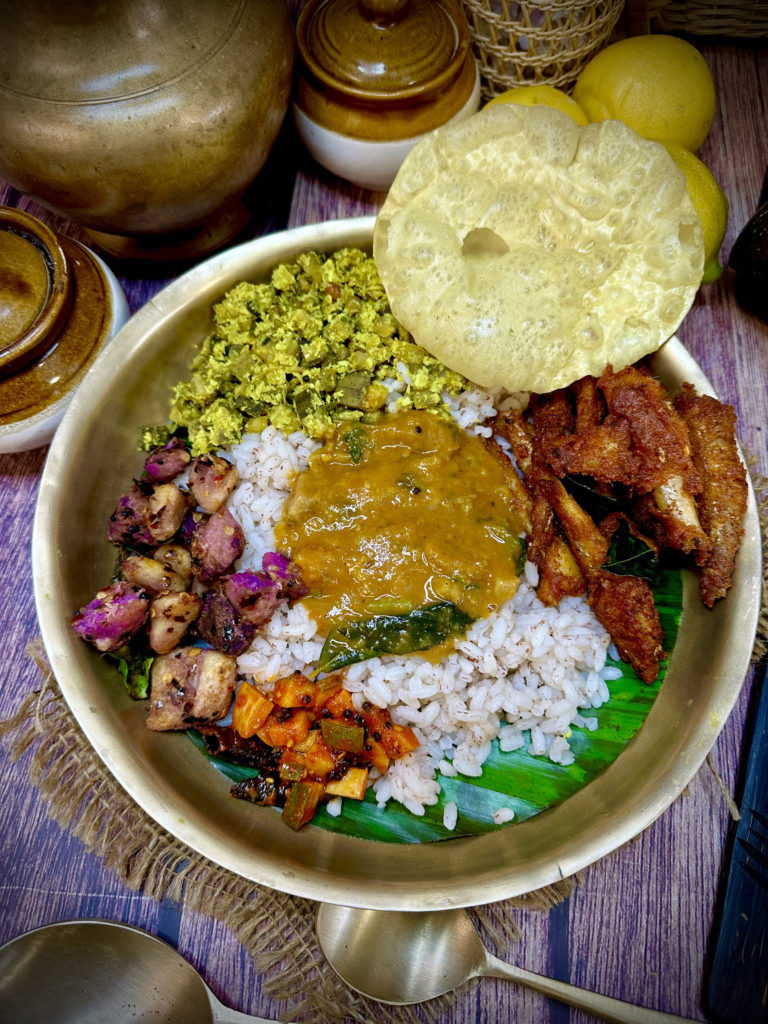 Kerala lunch bowl with fried fish, mango pickle, and much more.