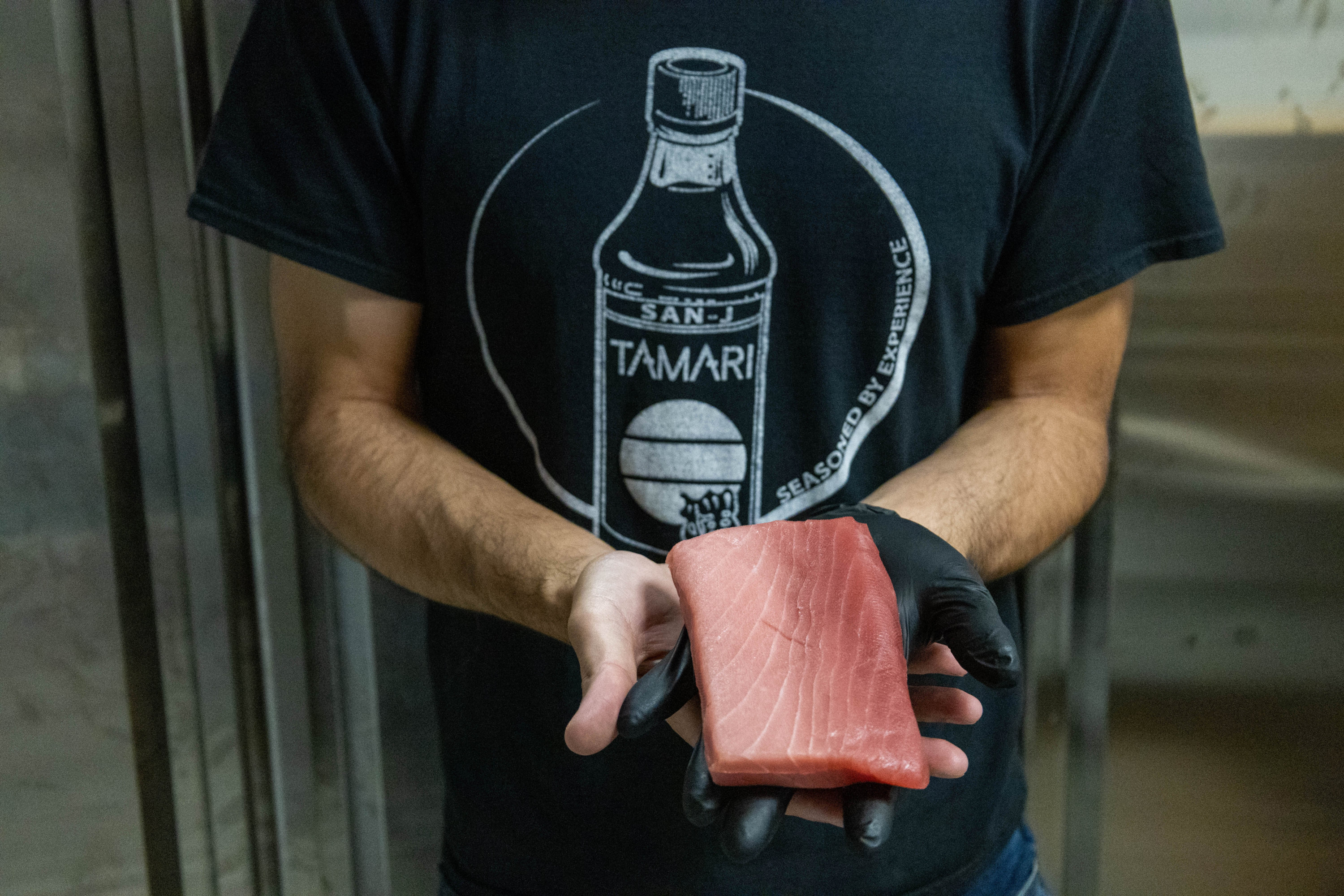 Keita Miyaki, fish importer posing at his busines in Ivy City - Washingtonian
