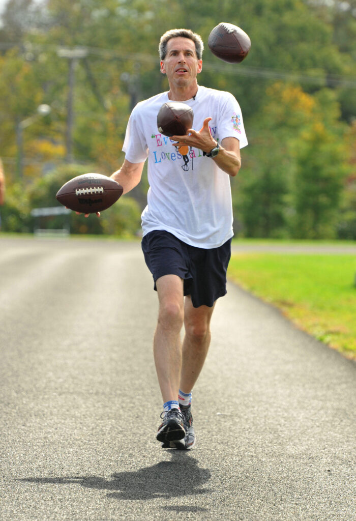 Barry Goldmeier, 50, a Rockville, Md., resident who works as a statistician, will be running in the Baltimore Running Festival while juggling. He does 20 to 25 marathons in the U.S. every year, and always juggles while he runs. © Amy Davis/Baltimore Sun/ - Washingtonian