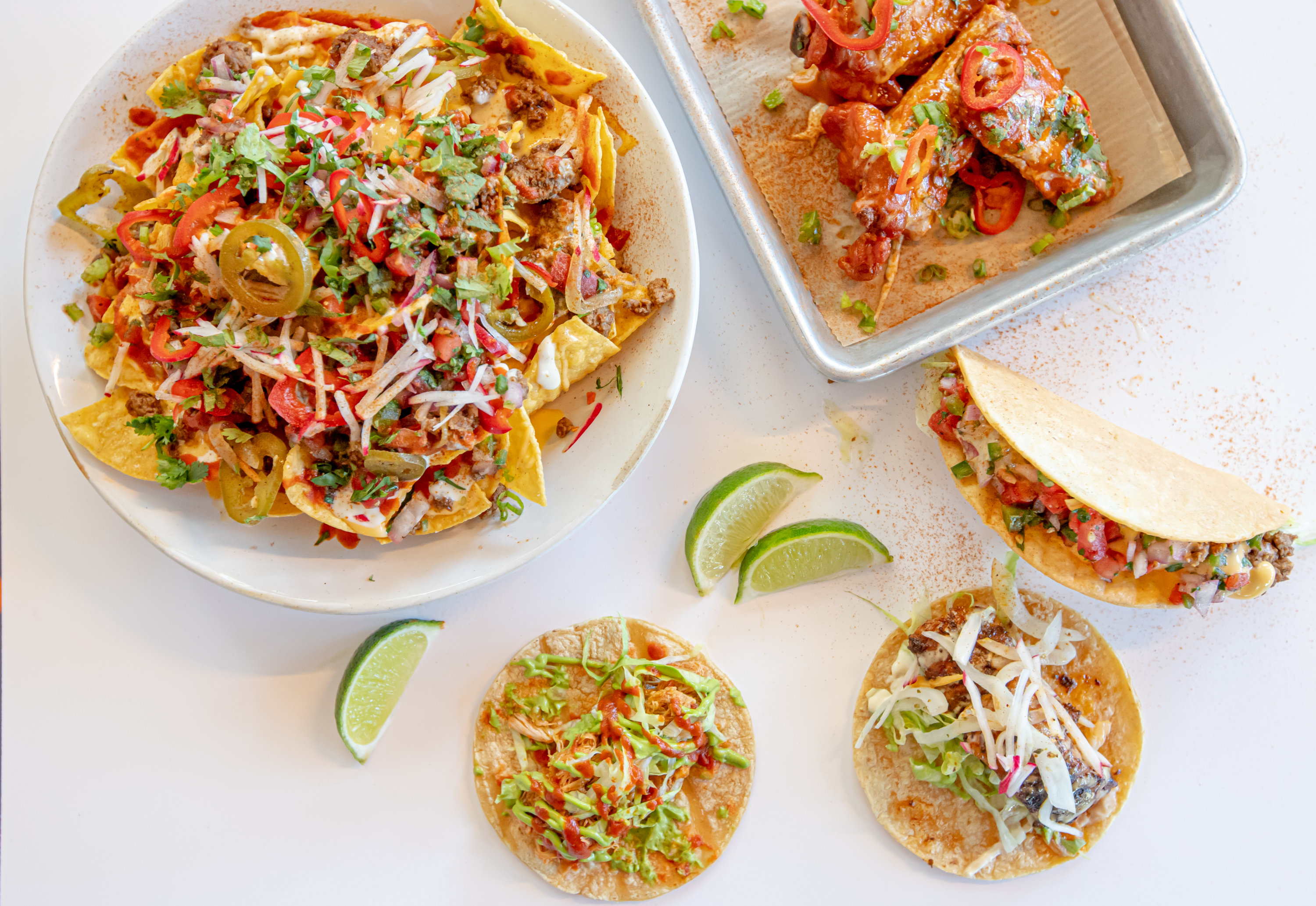 Kitchen sink nachos, tacos, and wings from Hi/Fi Taco at the Roost. Photo courtesy of Stacey Windsor. - Washingtonian Kitchen sink nachos, tacos, and wings from Hi/Fi Taco at the Roost. Photo courtesy of Stacey Windsor.