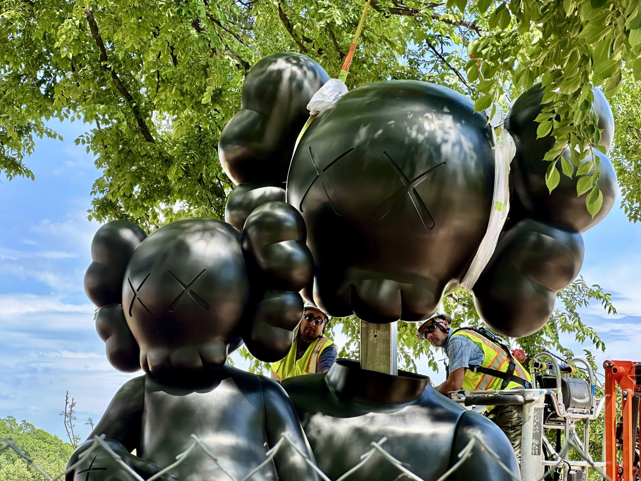 KAWS's 14-foot bronze sculpture SHELTER installed in the Hirshhorn Sculpture Garden