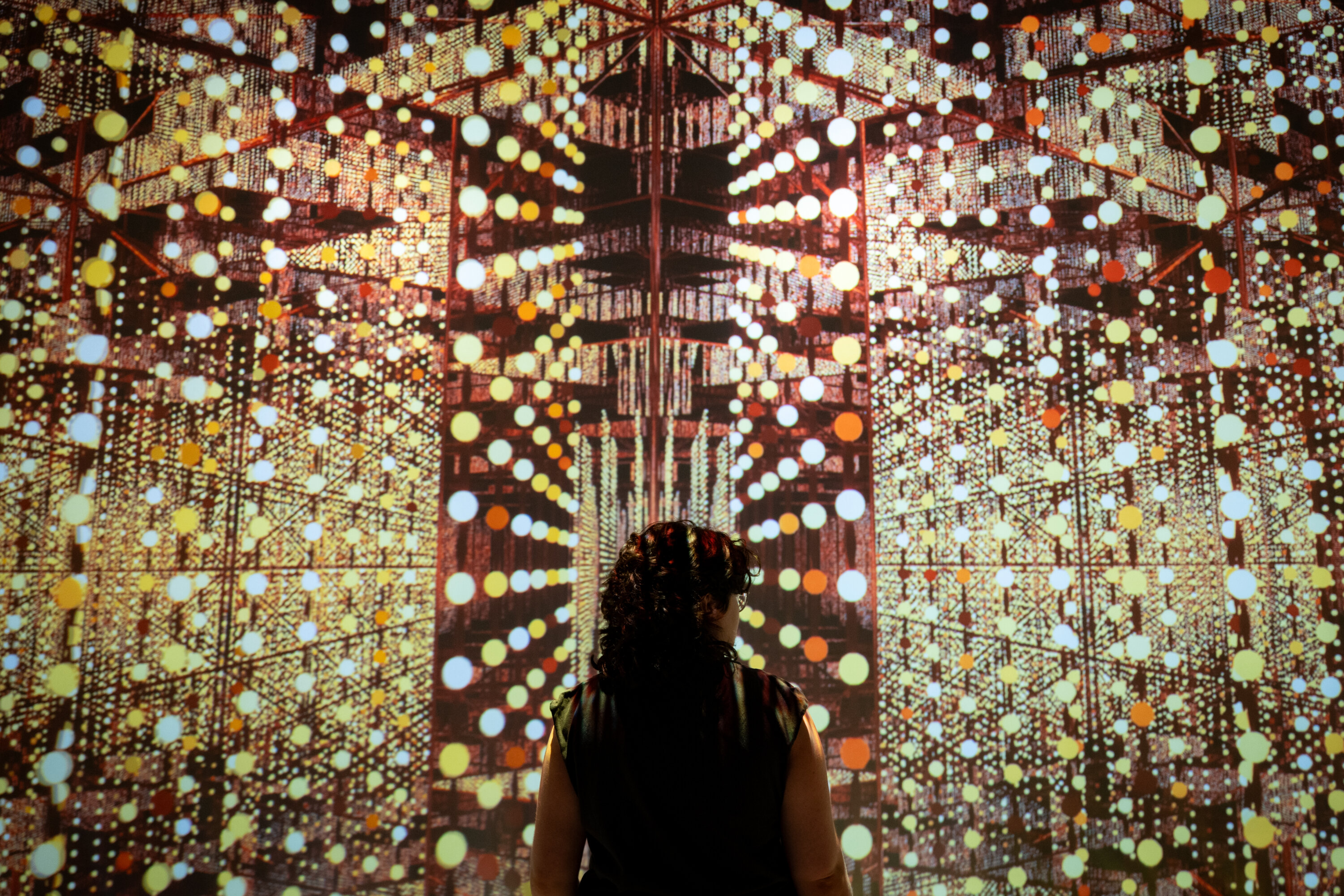 Picture of the "Submerge Project exhibition at Artechouse shows colorful dots scattered across the scene in geometric patterns.