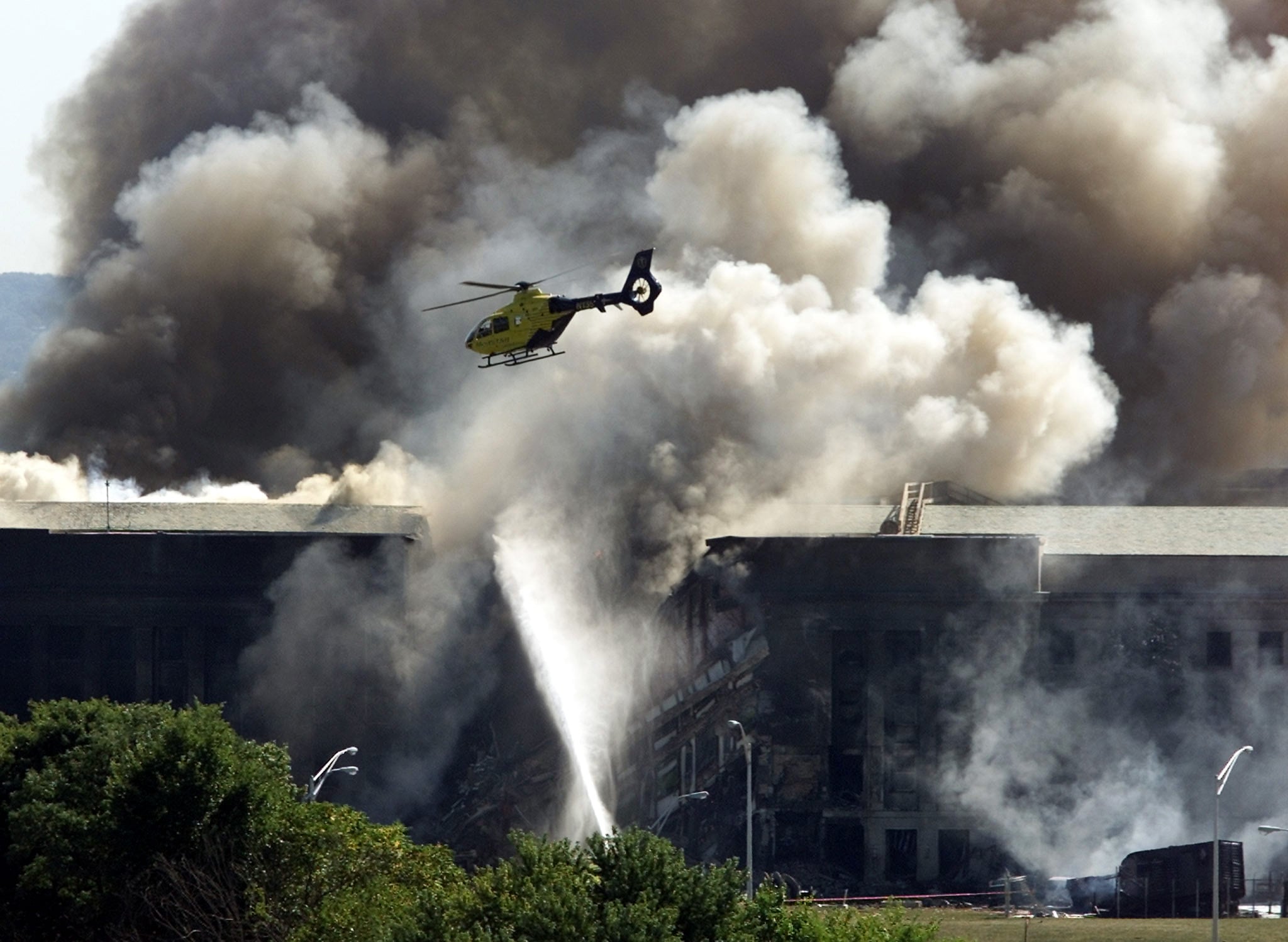 Rescue helicopter surveys damage to the Pentagon Building as fire fighters battle flames after an ap - Washingtonian Rescue helicopter surveys damage to the Pentagon Building as fire fighters battle flames after an ap..