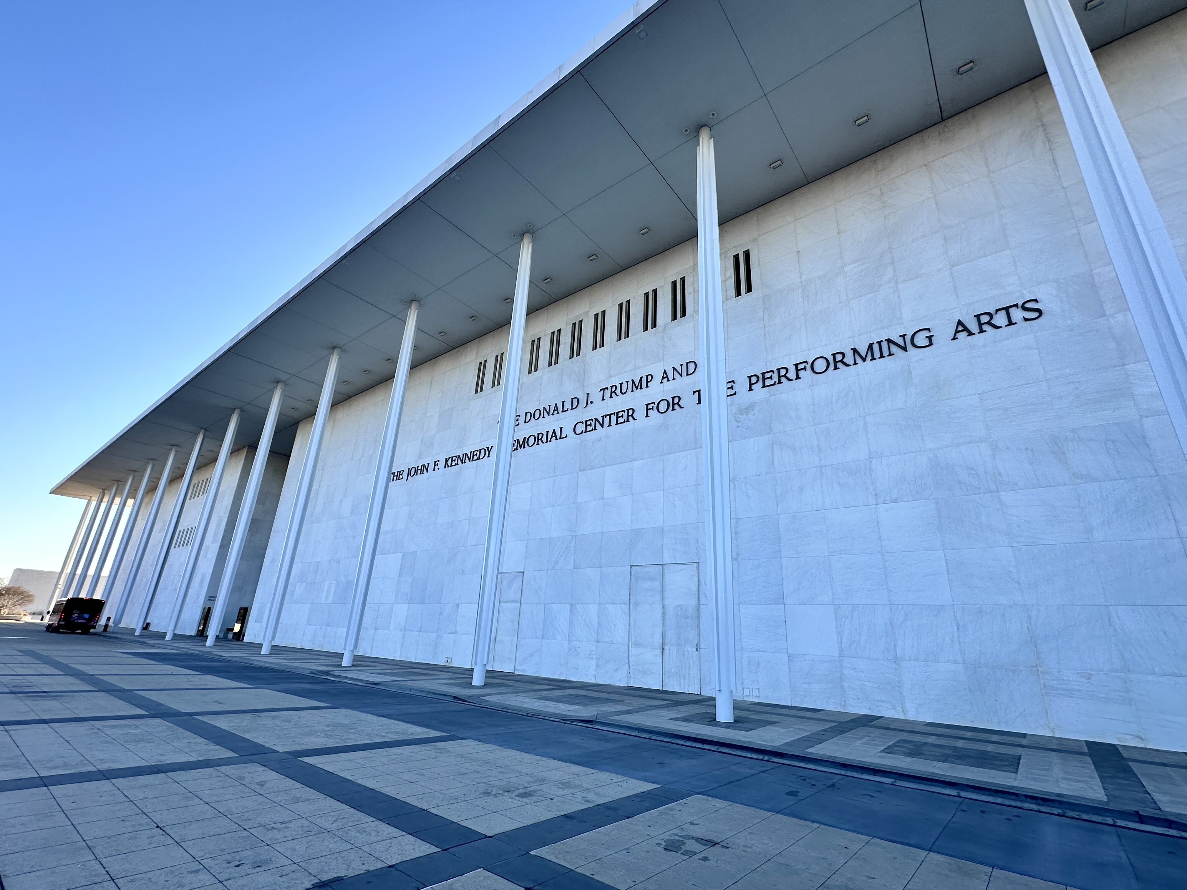 The front of the Kennedy Center in Washington DC, the sign reads "The Donald J Trump and John F Kennedy Center for the Performing Arts.