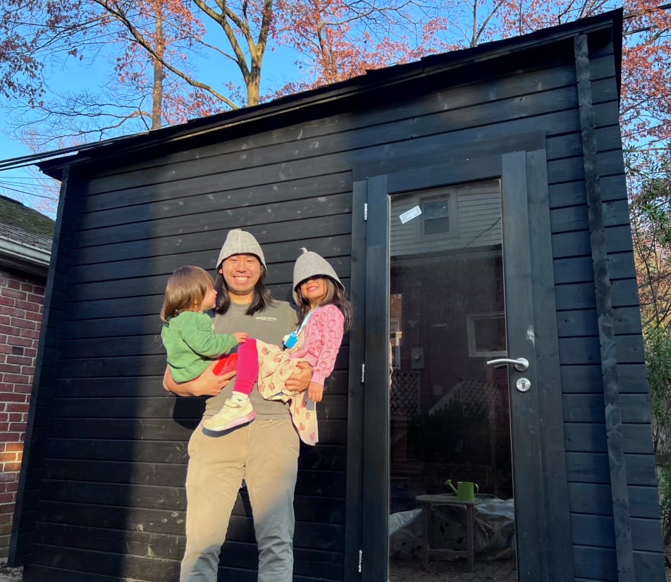 Hu and his children in front of his sauna, wearing traditional Finnish sauna caps. Photo courtesy of Steven Hu. 
